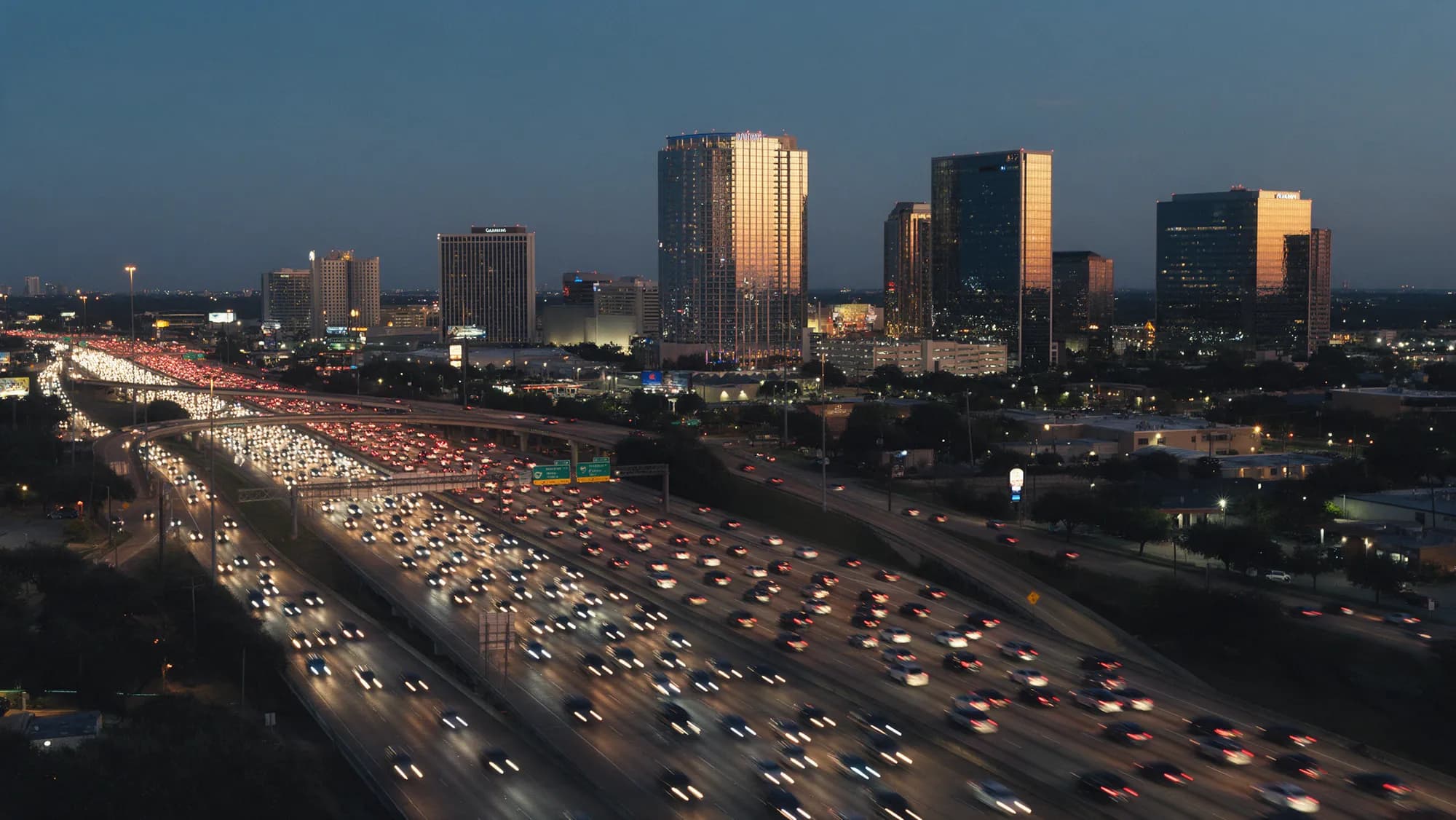 Heavy traffic on the West Loop near the Galleria towers at dusk