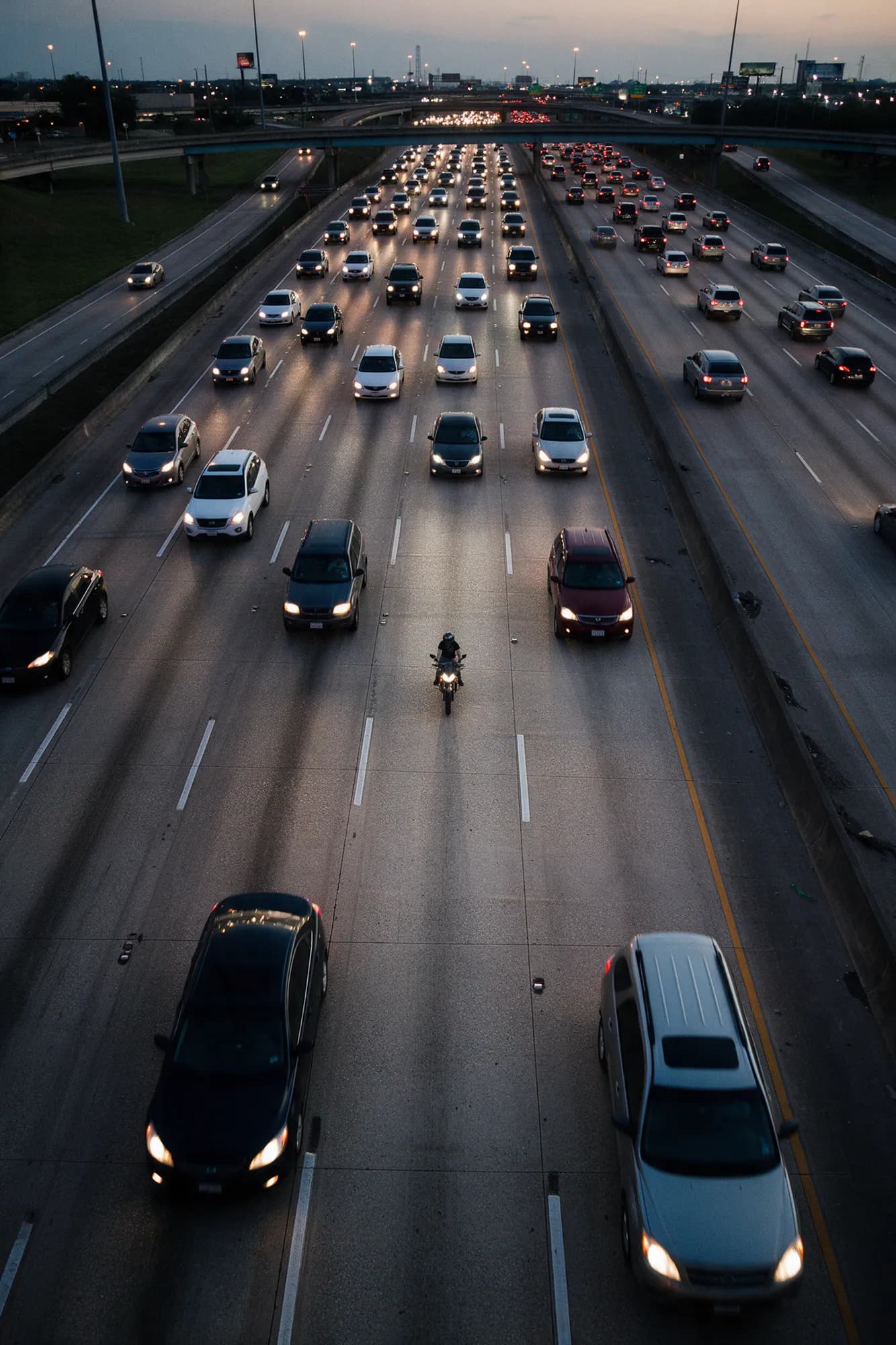 Aerial view of a motorcycle riding in its own lane in Houston freeway traffic