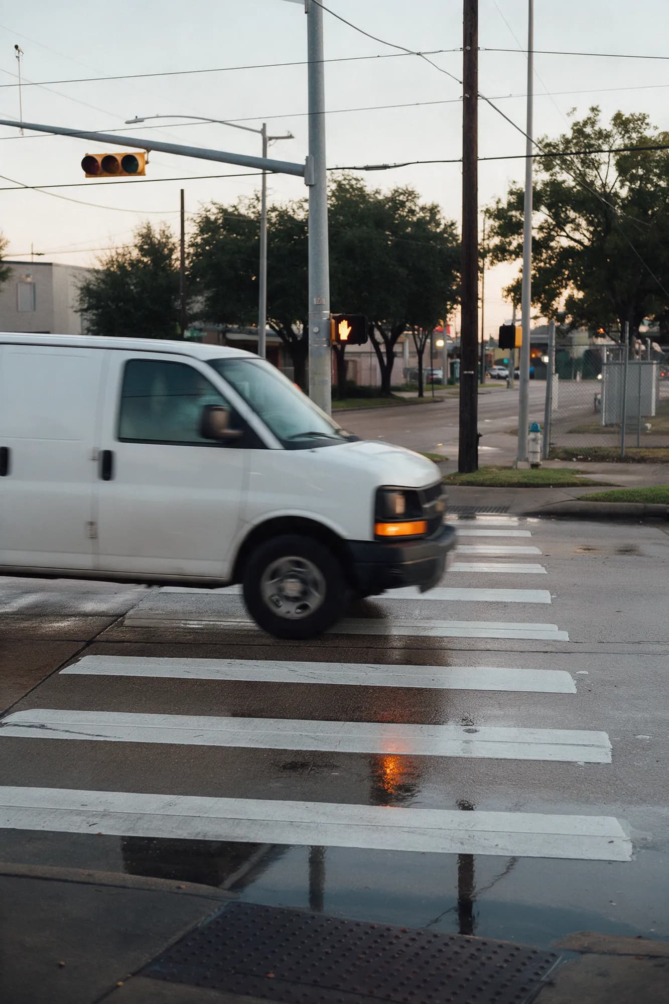 A delivery van turning through a crosswalk at a Houston intersection
